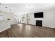 Bright living room with hardwood floors, a fireplace, and large windows, creating a cozy and inviting atmosphere at 304 Garden Walk Dr, Durham, NC 27703