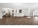 Spacious open-concept home with hardwood floors, an adjacent dining space, and access to the stairwell at 304 Garden Walk Dr, Durham, NC 27703