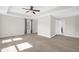 Bright main bedroom featuring neutral walls, carpet, ceiling fan, and an ensuite bathroom access at 304 Garden Walk Dr, Durham, NC 27703