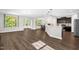 Expansive open-concept layout showcasing hardwood floors, a dining area, and a sleek kitchen with pendant lighting at 304 Garden Walk Dr, Durham, NC 27703