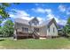 Charming home exterior boasts a large backyard, perfect for outdoor activities and relaxation at 305 Avent Meadows Ln, Holly Springs, NC 27540