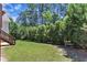 A lush backyard surrounded by mature trees provides a peaceful and private outdoor space at 305 Avent Meadows Ln, Holly Springs, NC 27540