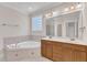 Bathroom with soaking tub, double sink vanity, and tile flooring at 305 Avent Meadows Ln, Holly Springs, NC 27540