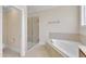 Bathroom features a soaking tub, glass enclosed shower, and tile flooring at 305 Avent Meadows Ln, Holly Springs, NC 27540
