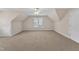Carpeted bonus room offering a versatile space with a large window at 305 Avent Meadows Ln, Holly Springs, NC 27540