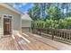 Inviting deck with wood railing is perfect for entertaining and relaxation with backyard access at 305 Avent Meadows Ln, Holly Springs, NC 27540