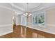 The dining room offers a decorative light fixture, molding and large windows at 305 Avent Meadows Ln, Holly Springs, NC 27540