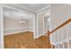 Elegant dining room view from the stairs with hardwood floors and a chandelier at 305 Avent Meadows Ln, Holly Springs, NC 27540