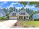 Traditional home with a well-kept lawn, front porch, and attached two-car garage in a friendly neighborhood at 305 Avent Meadows Ln, Holly Springs, NC 27540