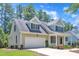 Charming home with a well-manicured lawn, inviting front porch, and attached two-car garage at 305 Avent Meadows Ln, Holly Springs, NC 27540