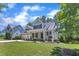 Inviting home with a manicured lawn, mature trees, and an attached two-car garage in a friendly neighborhood at 305 Avent Meadows Ln, Holly Springs, NC 27540