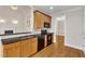 Traditional kitchen with black countertops, wood cabinets, and black appliances at 305 Avent Meadows Ln, Holly Springs, NC 27540