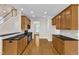 The kitchen features granite countertops, black appliances, and wooden cabinets at 305 Avent Meadows Ln, Holly Springs, NC 27540