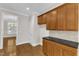 The kitchen features granite countertops, wooden cabinets, hardwood floors, and an open layout at 305 Avent Meadows Ln, Holly Springs, NC 27540