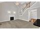 This living room has a fireplace, high ceilings, and a staircase at 305 Avent Meadows Ln, Holly Springs, NC 27540