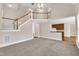 The open-concept living room provides high ceilings, a staircase and an eat-in kitchen at 305 Avent Meadows Ln, Holly Springs, NC 27540
