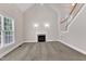 This living room has a fireplace, vaulted ceilings, neutral carpeting and a staircase at 305 Avent Meadows Ln, Holly Springs, NC 27540