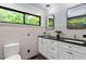 Spacious bathroom showcasing a double vanity, subway tile, and a sleek black-framed window at 3213 Mid Pines Rd, Raleigh, NC 27606