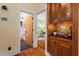 Bathroom view with wood cabinets and doorway access to another room at 3213 Mid Pines Rd, Raleigh, NC 27606