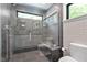 Modern bathroom with glass enclosed shower, gray tile, and lots of natural light at 3213 Mid Pines Rd, Raleigh, NC 27606