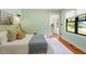 Bedroom with green walls, wood floors, and bright window at 3213 Mid Pines Rd, Raleigh, NC 27606
