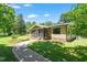 Bungalow with well-maintained lawn, screened-in porch, and a brick walkway at 3213 Mid Pines Rd, Raleigh, NC 27606