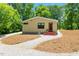 Charming home with red door and surrounded by trees and gravel driveway at 3213 Mid Pines Rd, Raleigh, NC 27606