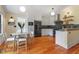 Bright eat-in kitchen featuring white cabinets, stainless appliances, and wood floors at 3213 Mid Pines Rd, Raleigh, NC 27606