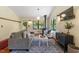 Living room featuring a cozy seating area, wood burning stove, and natural light at 3213 Mid Pines Rd, Raleigh, NC 27606