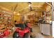 Interior shot of outbuilding showing lawn mower, workbench, storage cabinets, and insulated walls and ceiling at 3213 Mid Pines Rd, Raleigh, NC 27606