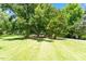 Lush yard featuring mature trees, well-manicured grass, and plenty of space to roam at 3213 Mid Pines Rd, Raleigh, NC 27606