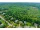 An aerial view of a lush, green neighborhood featuring well-manicured lawns and tree-lined streets at 322 Bellemont Rd, Pittsboro, NC 27312