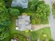 A serene aerial view of a home nestled among lush green trees, with a well-maintained yard and inviting driveway at 322 Bellemont Rd, Pittsboro, NC 27312