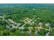 A stunning aerial view showcasing a neighborhood surrounded by verdant trees and landscaping at 322 Bellemont Rd, Pittsboro, NC 27312