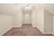 Attic space with sloped ceilings, neutral colors, carpet and a window at 322 Bellemont Rd, Pittsboro, NC 27312