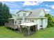 An elevated view of a home featuring a wood deck, screened in porch, and yard at 322 Bellemont Rd, Pittsboro, NC 27312