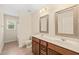 Bathroom features double sinks, wood cabinets, decorative mirrors and tile flooring at 322 Bellemont Rd, Pittsboro, NC 27312