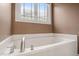 Relax in this soaking tub with chrome fixtures and a window view at 322 Bellemont Rd, Pittsboro, NC 27312