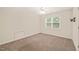 This bedroom features a ceiling fan, carpet, and a window for natural light at 322 Bellemont Rd, Pittsboro, NC 27312