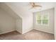 Light-filled bedroom with carpet, ceiling fan, and a view of the outdoors at 322 Bellemont Rd, Pittsboro, NC 27312