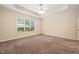 Large bedroom features neutral carpet, ceiling fan and natural light from a window at 322 Bellemont Rd, Pittsboro, NC 27312