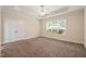 This spacious bedroom features plush carpeting, large windows, and neutral wall colors at 322 Bellemont Rd, Pittsboro, NC 27312