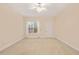 Bright bedroom features neutral carpet and a window with natural light at 322 Bellemont Rd, Pittsboro, NC 27312