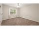 This bedroom features a ceiling fan, carpet, and a window for natural light at 322 Bellemont Rd, Pittsboro, NC 27312