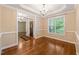 Formal dining room featuring hardwood floors, chandelier, and ample natural light at 322 Bellemont Rd, Pittsboro, NC 27312