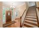 Inviting foyer with hardwood floors, chandelier, and staircase to the upper level at 322 Bellemont Rd, Pittsboro, NC 27312
