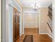 Elegant foyer featuring hardwood floors, chandelier, and staircase at 322 Bellemont Rd, Pittsboro, NC 27312