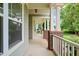 Expansive front porch featuring elegant columns, offering an inviting outdoor space at 322 Bellemont Rd, Pittsboro, NC 27312