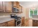 A fully equipped kitchen with stainless steel range and built-in microwave at 322 Bellemont Rd, Pittsboro, NC 27312