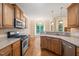 Well-equipped kitchen with stainless steel appliances and wooden cabinets, offering ample counter space at 322 Bellemont Rd, Pittsboro, NC 27312
